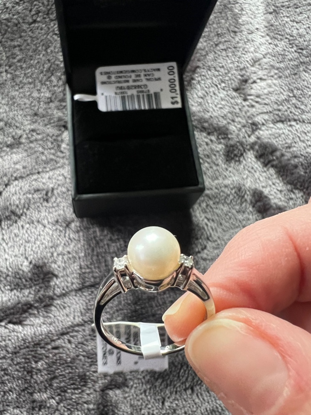 Freshwater pearls centered in round cut diamonds. 14 k white gold ring.